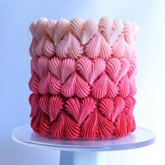 there is a cake that has pink and white icing on the top of it