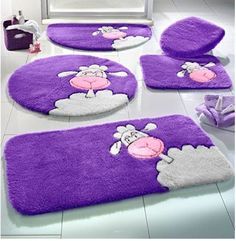 purple bathroom rugs with sheep on them and other items in the room around them