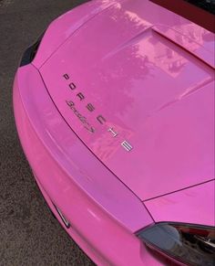 a pink sports car is parked on the street