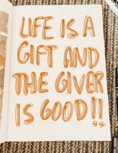 an open book with the words life is a gift and the giver is good