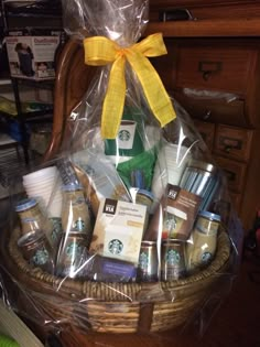 a basket filled with starbucks products and wrapped in plastic