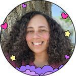 a woman with curly hair smiling in front of a tree and hearts around her face