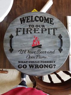 a sign that says, welcome to our firepit we have beer and open flame what could possibly go wrong?