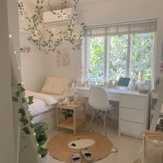 a bedroom with white furniture and plants on the wall