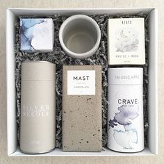 an open box containing various items such as cups, napkins and coasters with the words mast written on them