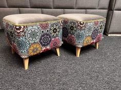 two upholstered stools sitting on top of a carpeted floor