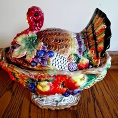 a turkey figurine sitting on top of a wooden table