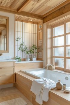 a bathroom with a large bathtub next to a window filled with potted plants