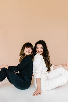 Two friends model in matching black and white Free People jumpsuits in a photoshoot with a tan backdrop by Savage Seamless Paper. The girl on the left is wearing a black utility jumpsuit and the girl on the right is wearing a cream colored jumpsuit. They girls are laughing. Friend Portraits Photography, Editorial Friends Photoshoot, 2 Females Photoshoot, Best Friend Indoor Photoshoot, Best Friend Editorial Shoot, Photoshoot For 2 People, Two Ladies Photoshoot, Two People Studio Photoshoot, Photoshoot For Two Friends