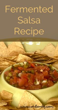 a bowl filled with salsa surrounded by tortilla chips