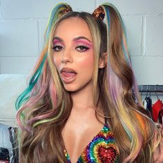 a woman with long hair and rainbow makeup