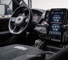 the interior of a car with an electronic display on the dash board and steering wheel