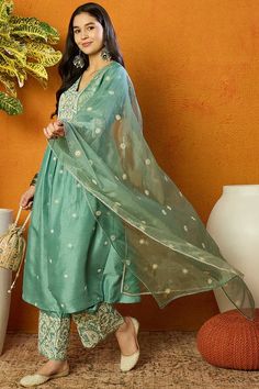 This beautiful sea green silk blend anarkali suit set is perfect for any special occasion. The suit features a solid yoke with intricate embroidery, a full-length anarkali kurta, and matching pants. The kurta has a flattering A-line silhouette and is adorned with delicate lace trim. The pants are slim-fitting and have an elastic waistband for a comfortable fit. Style NoteComplete the LookThis suit set can be dressed up or down depending on the occasion. For a more formal look, add some jewelry a Farewell Suits For Women, Suit For Farewell, Sea Green Suit, Anarkali Kurta Set, Silk Anarkali Suits, Silk Anarkali, Sea Green Color, Dress Book, Embroidered Anarkali