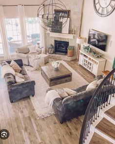 a living room filled with lots of furniture and a fire place in the middle of it