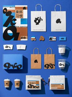 various paper bags and coffee cups on a blue surface