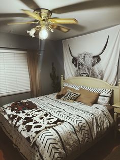 a bedroom with a cow head on the wall and a bed in front of it