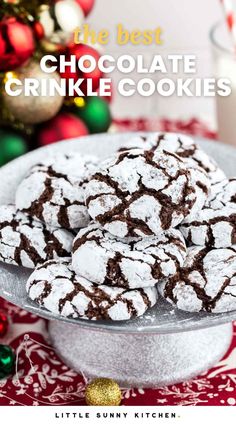 the best chocolate crinkle cookies on a platter with christmas decorations in the background