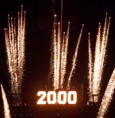 fireworks are lit up in the night sky above a sign that reads 200th birthday