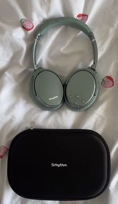 headphones and case laying on a white sheet