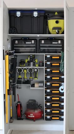 an organized garage storage unit with tools and other items in it's cabinet door