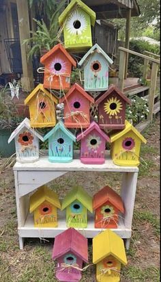 colorful bird houses are stacked on top of each other