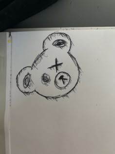 a drawing of a teddy bear with a cross on it