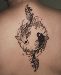 a woman's back with two fish in the water