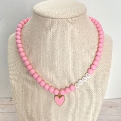 Your little one will love to accessorize with this cute heart necklace! It is made with matte pink beads and a heart charm. It will make any outfit more special! Personalize it with any name :-) This stretchy necklace fits right over your head so it's easy to put on- no clasps needed. 🤍 Please check all selections and spelling prior to check out. Our custom jewelry is made to order so all sales are final. 🤍 The necklace is beautifully packaged and ready to gift. Receipts are never included. If Necklace For Kids, Pink Heart Necklace, Best Valentine Gift, Valentine Gifts For Kids, Heart Charm Necklace, Valentine Gifts For Girlfriend, Matte Pink, Valentines Gifts For Boyfriend, Concert Fits