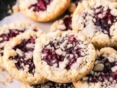 several cookies with crumbs and powdered sugar on top