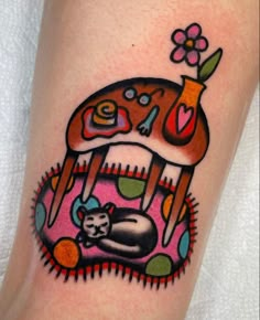 an artistic tattoo design on the leg of a woman's arm with a dog and cat