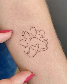 a woman's arm with a small tattoo on it