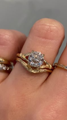 A matching wedding set featuring our Pembroke - a nature inspired solitaire engagement ring with leaf details and a split shank band. She's paired with our Vennie, a nature inspired contoured wedding band with leaf details. Drop-down diamond options represent our recommended grade, which maximizes size for value, while maintaining eye-perfect clarity and giving you a colorless look. For other diamond options, see our Shop Diamonds tab or speak to one of our design consultants. Rings in this set Flower Engraved Engagement Ring, Tree Branch Engagement Ring, Engagement Ring With Other Rings On Hand, Wrap Diamond Ring, Art Deco Band Ring, Northway Studio Ring, Band For Oval Engagement Ring, Solitaire Engagement Ring And Wedding Band, Engagement And Wedding Band Set