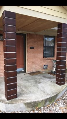 an outside view of a house with brick pillars