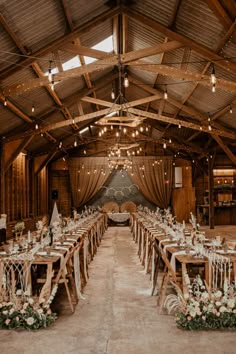 the inside of a barn with tables and chairs