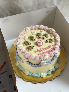 a birthday cake with teddy bears on it in a box for someone's special occasion