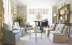 a living room filled with furniture and a piano