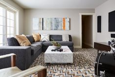 a living room filled with furniture and a flat screen tv on top of a wall