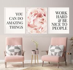 two pink chairs in front of a wall with posters on it