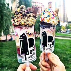 two ice cream sundaes with sprinkles and toppings on them