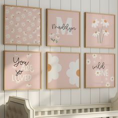 a baby's nursery room with pink and white wall art on the walls, including daisies