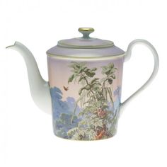 a tea pot with a painting on it