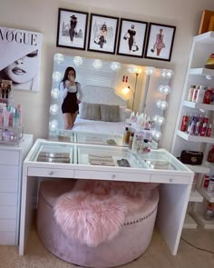 a woman is standing in front of a vanity with lights on and a stool underneath it