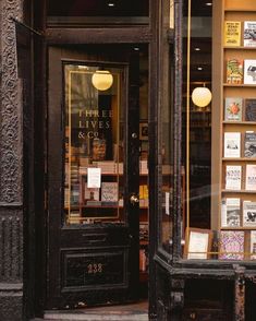 there is a store front with many books on the shelves and in the window display