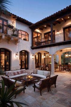 an outdoor living area with furniture and lights