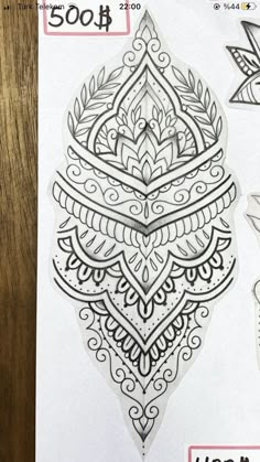 an intricate tattoo design is shown on the back of a sheet of paper with stickers