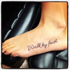 a foot with the words walk by faith written on it and an image of a woman's feet