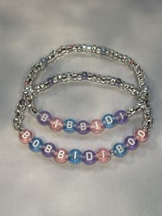 Your own personal fairy godmother on your wrist! Bibbidi Bobbidi Boo! Done in pink, purple, and blue letter beads surrounded with simple elegant silver lined clear crystal glass seed beads. Perfect for any princess!  Bracelets are available in a variety of lengths.  Pick your custom length from the drop down menu below.  All our bracelets are made with quality in mind.  With that being said, all bracelets should be treated with care while putting on, wearing, and taking off.  Keep dry. Do not sw Princess Bracelets, Bibbidi Bobbidi Boo, Princess Fairy, Fairy Godmother, Silver Line, Letter Beads, Holiday Jewelry, Glass Seed Beads, Godmother