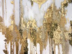 an abstract painting with gold and white paint