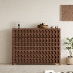 a living room with a large wooden cabinet and rugs on the floor in front of it