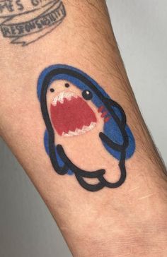 a person's arm with a tattoo on it that has an image of a cartoon character